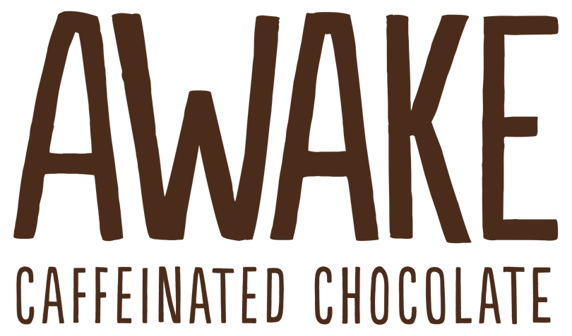 The Awake Chocolate logo displays bold, brown uppercase text reading "AWAKE" with "CAFFEINATED CHOCOLATE" in smaller uppercase letters below.