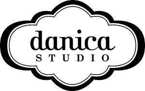 The Danica Studio logo shows “danica” in script above “STUDIO” in uppercase, framed by a black decorative outline.