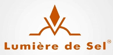 The Lumière de Sel logo features an orange geometric symbol resembling a rising crystal above a curved line, with the brand name “Lumière de Sel” written below in bold orange lettering.