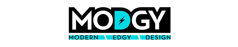 The Modgy logo features bold white letters on a black background, with the turquoise “D” containing a lightning bolt and the tagline “Modern | Edgy | Design” below it.