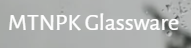 The MTNPK Glassware logo shows the brand name in a simple white font on a grey background with light water droplets, reflecting clarity and craftsmanship.