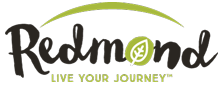 The Redmond Real Salt logo shows “Redmond” in black script with a green leaf inside the “o,” a green arc above, and the tagline “LIVE YOUR JOURNEY™” below.
