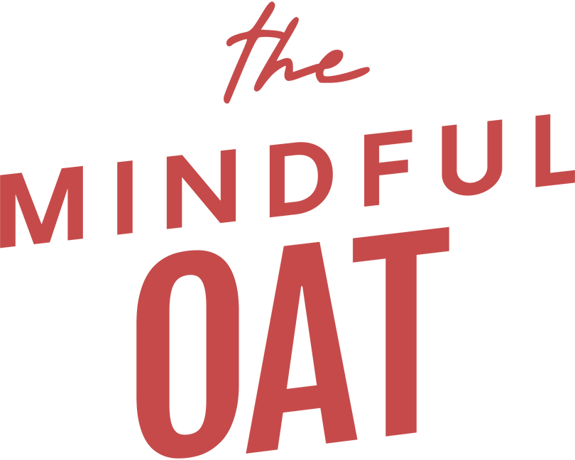 The logo for The Mindful Oat features bold, modern red lettering on a black background, with the words “Mindful Oat” in large uppercase letters and the word “The” written above in a handwritten script style, giving it a calm, artisanal feel.