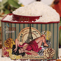 White cocoa butter bath soak powder overflowing from an ornate Ruby Red collection decorative metal container.